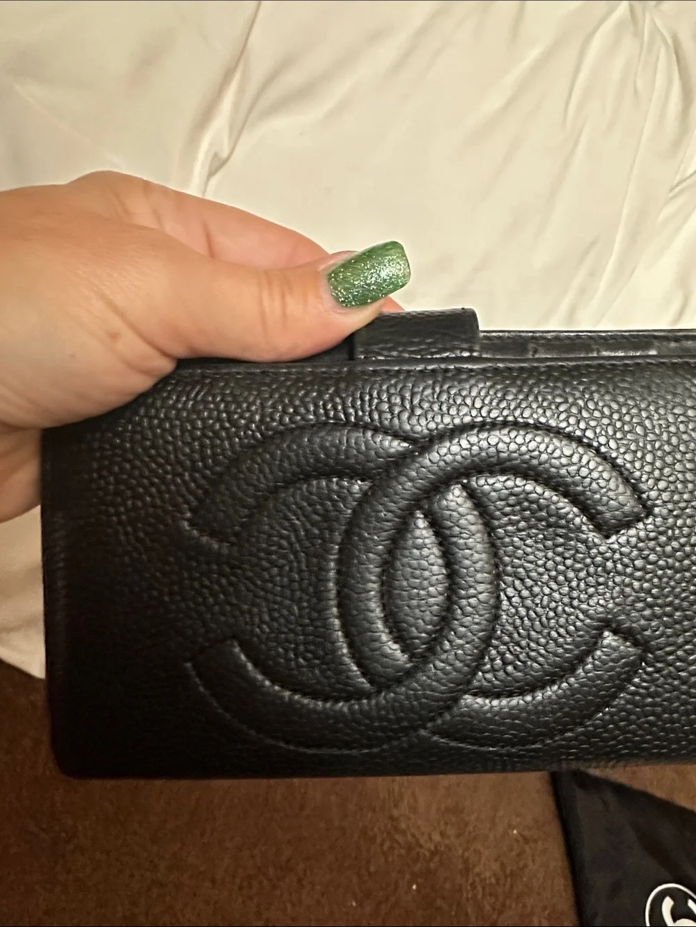 CHANEL Black Quilted CC Caviar Leather wallet.
